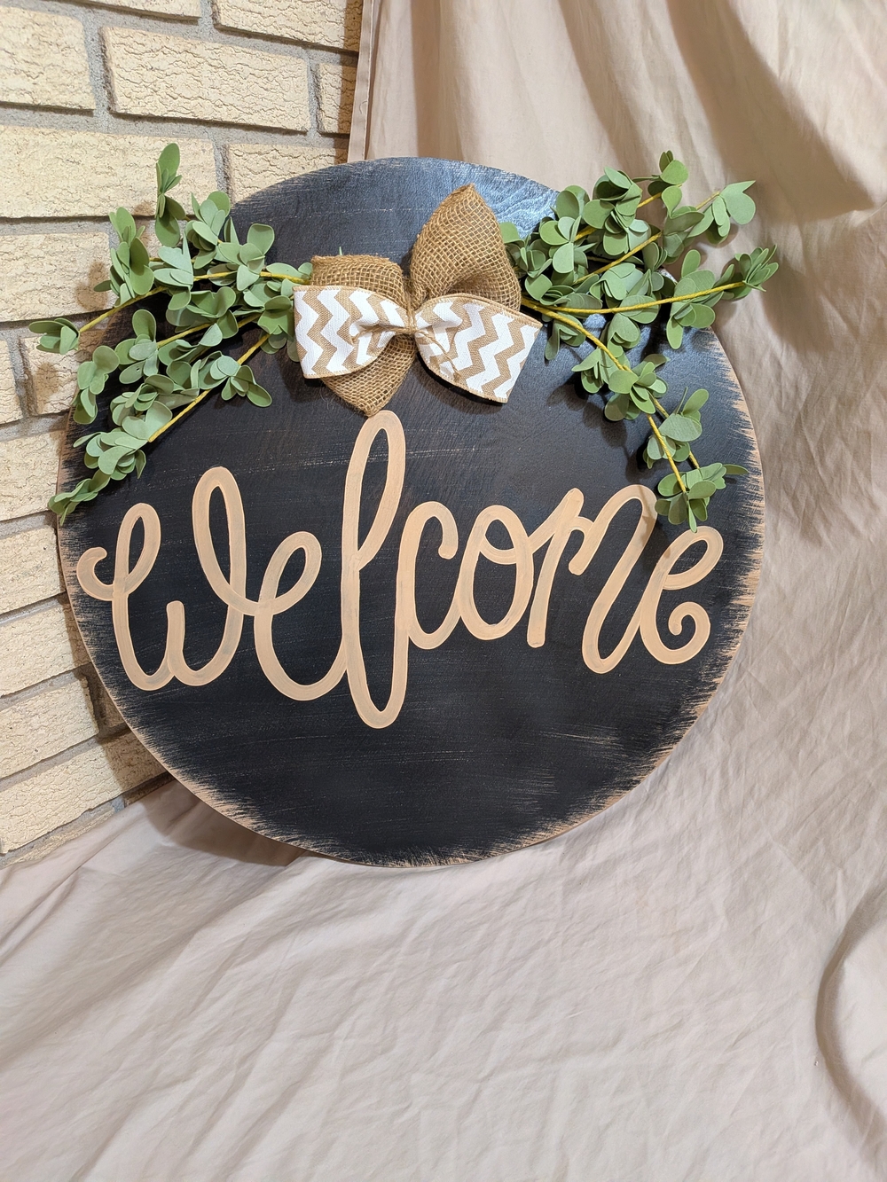 Welcome Round Wooden Sign with Greenery and Burlap Bow - Black and Natural